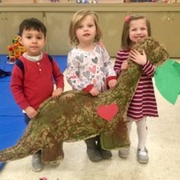 Tiny Tots Program Students holding stuffed dinosaur