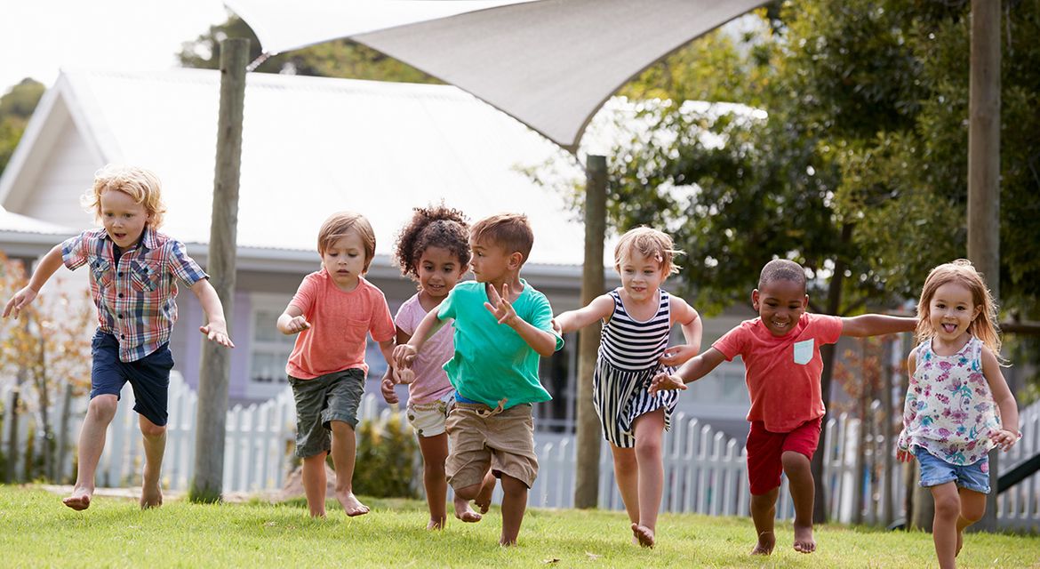 Young preschool kids running outside