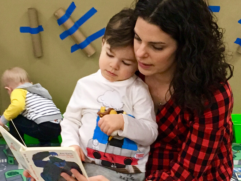 Mother reading to son at Mommy & Me Program